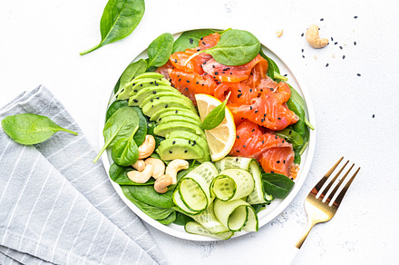 Keto salad with salmon, avocado, spinach, cucumber, sesame seeds, a Food & Drink Photo by 5PH