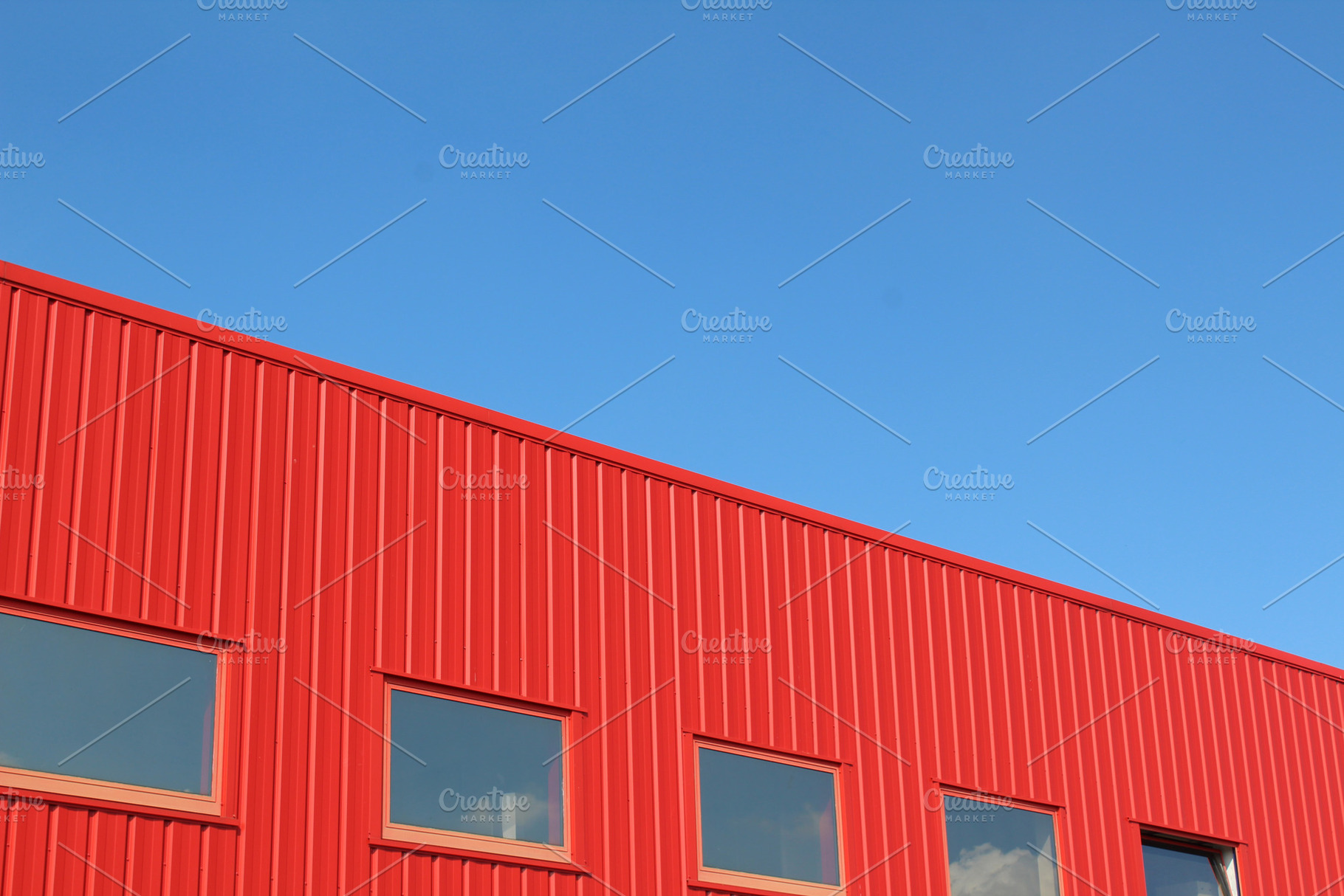 Red building with blue sky stock photo containing urban and geometry, an Architecture Photo by The Pixels Factory