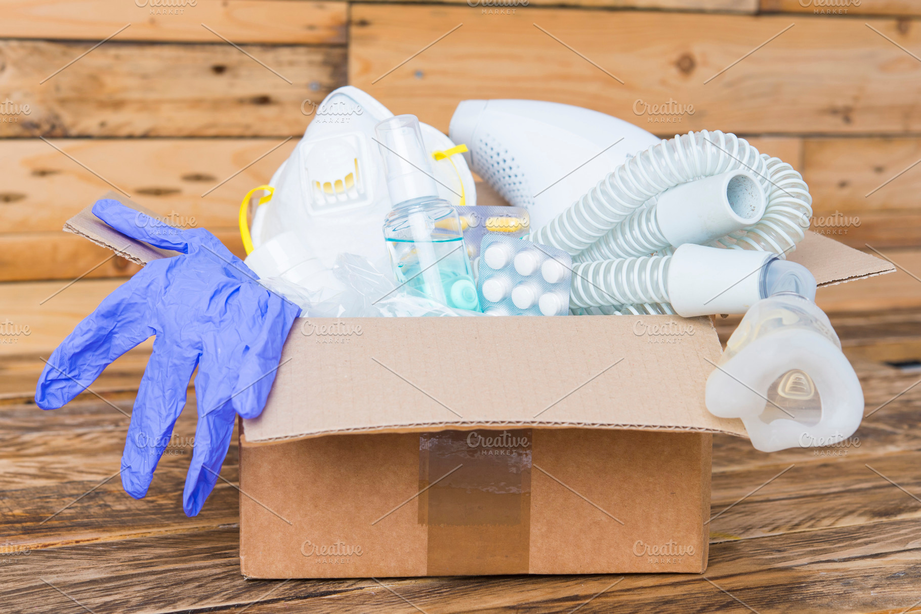 Donation box in a pandemic front vie stock photo containing alcohol gel and, a Health & Medical Photo by DalaiFood