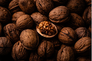 Cracked walnut among whole nuts, a Food & Drink Photo by Yulia Furman