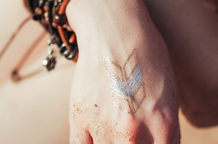 Close up hands with boho accessories containing jewelry, bohemian, and boho