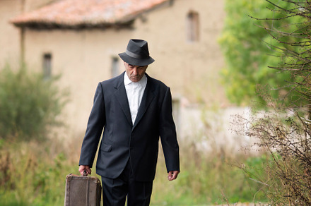 emigrant with suitcase and vintage suit leaving his village to l