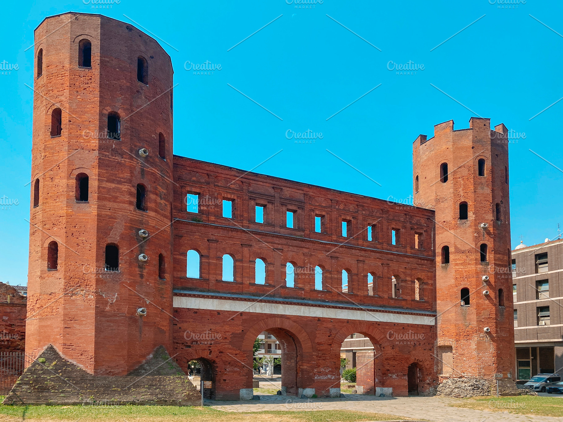 a frontal view of the Porta Palatina in Turin, a Photo by Nito