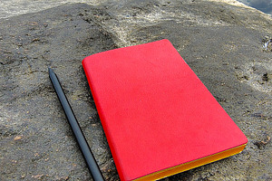 Notebook and a pencil rest on a rugged rock along a rocky beach,, a Sports & Recreation Photo by DanFLCreativo