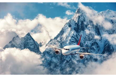 Airplane is flying over clouds, a Transportation Photo by den-belitsky