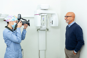 Dentist taking pictures of senior patient with professional came, a Photo by Antonio Gravante Market