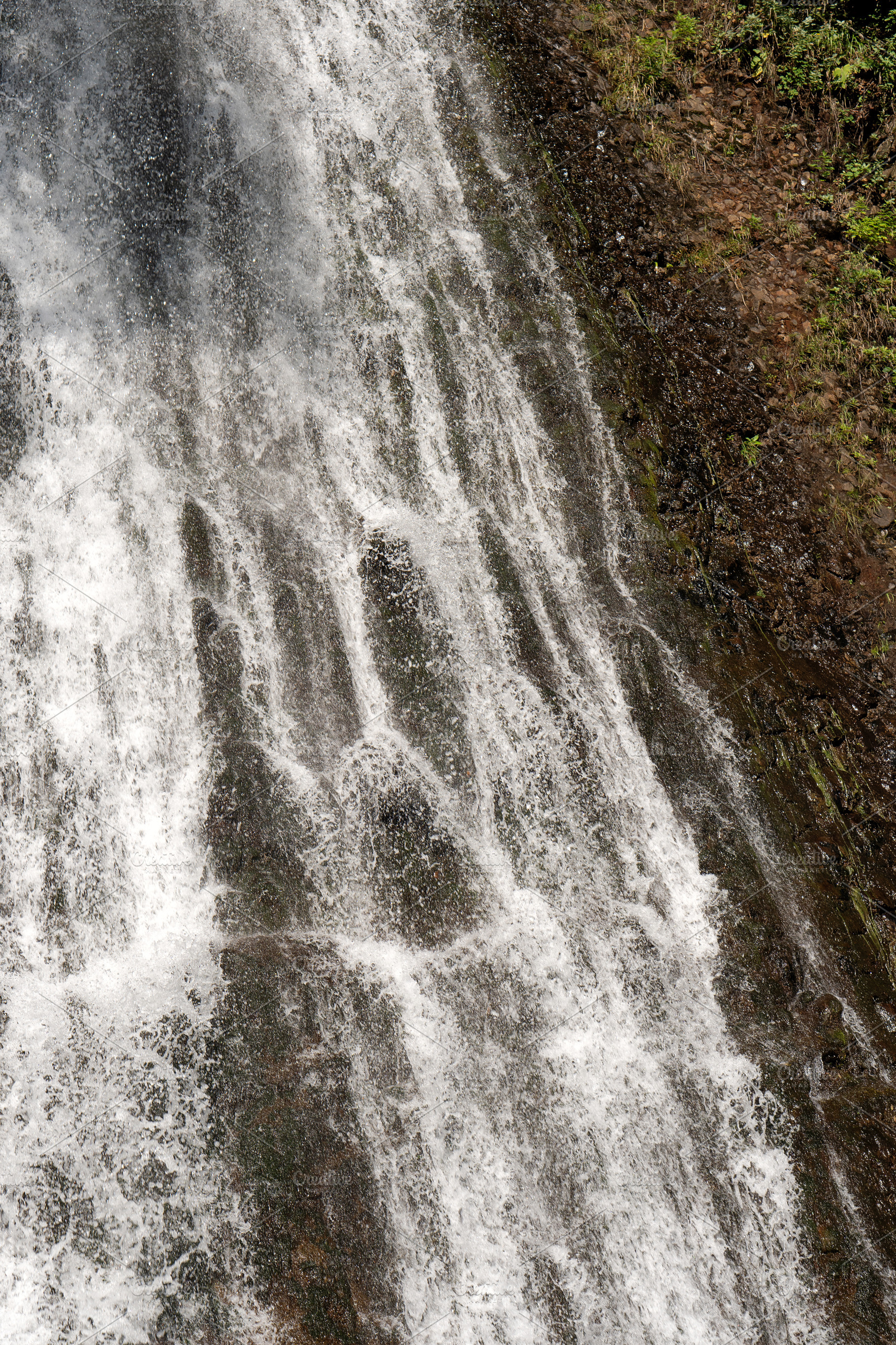 Waterfall flowing over dark rocky, a Nature Photo by Elena Vagengeim