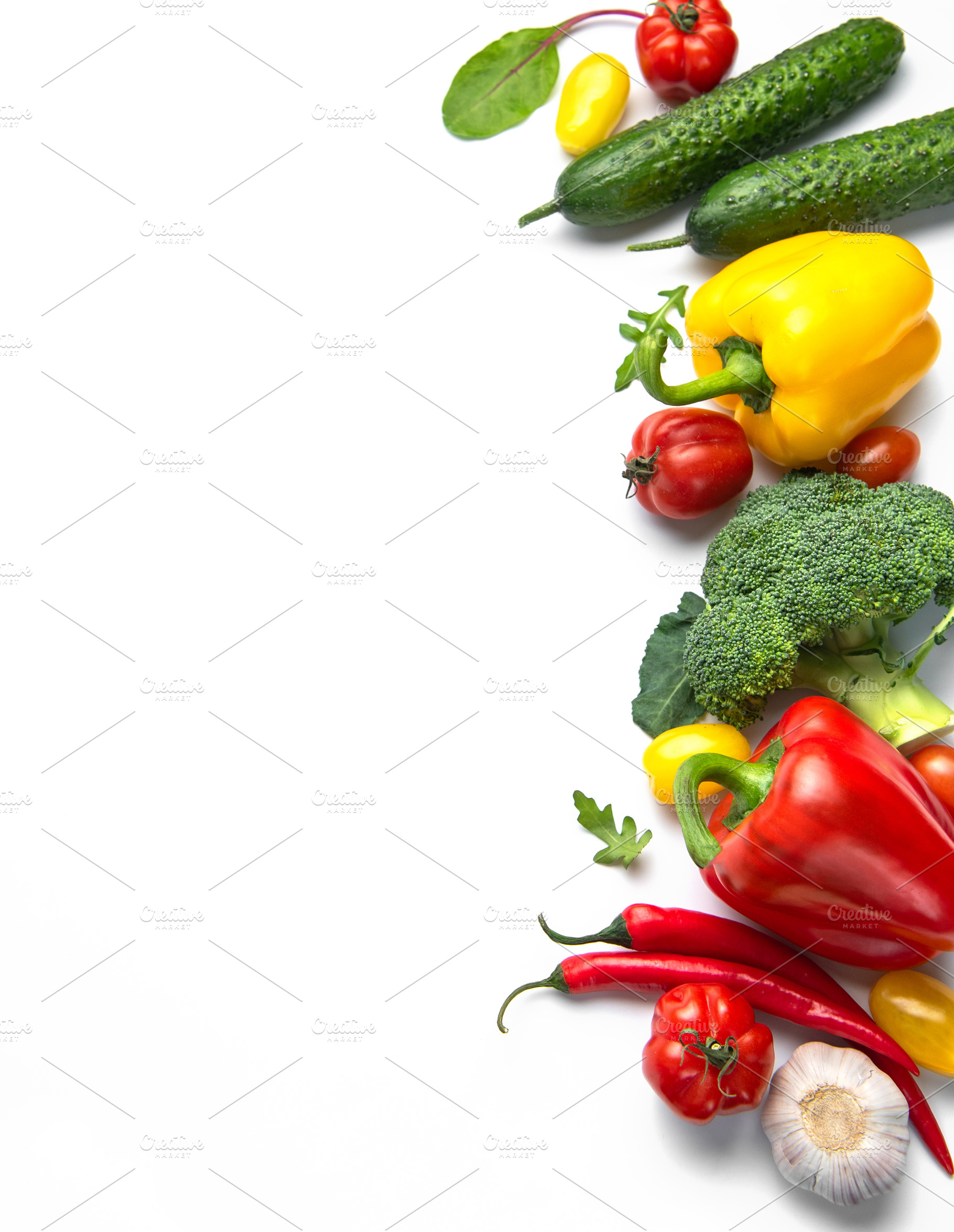 Fresh organic healthy vegetables forming colorful border on whit, a Food & Drink Photo by Olena Rudo