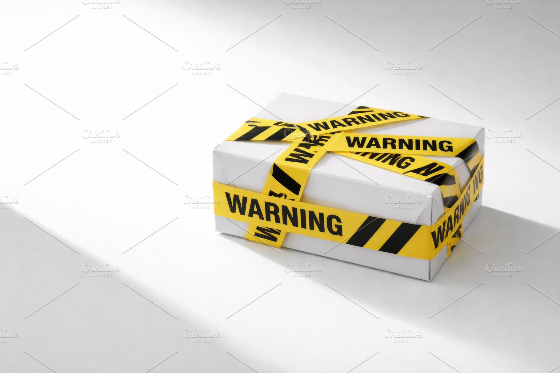 Package wrapped in yellow warning ta, a Photo by Dvoevnore photos