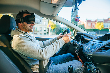 Man in car with VR glasses