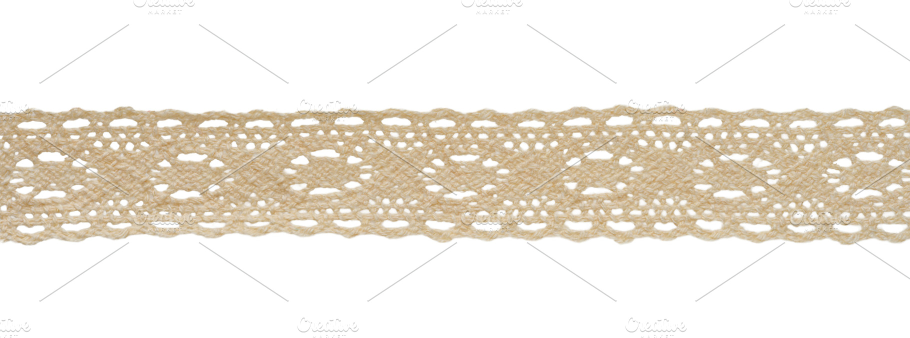 A strip of beige openwork cotton lace ribbon with a geometric pa, an Abstract Photo by ndanko
