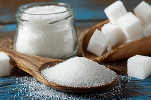 White sugar in granular and cube forms, a sweet food ingredient, a Photo by Studio ANNA