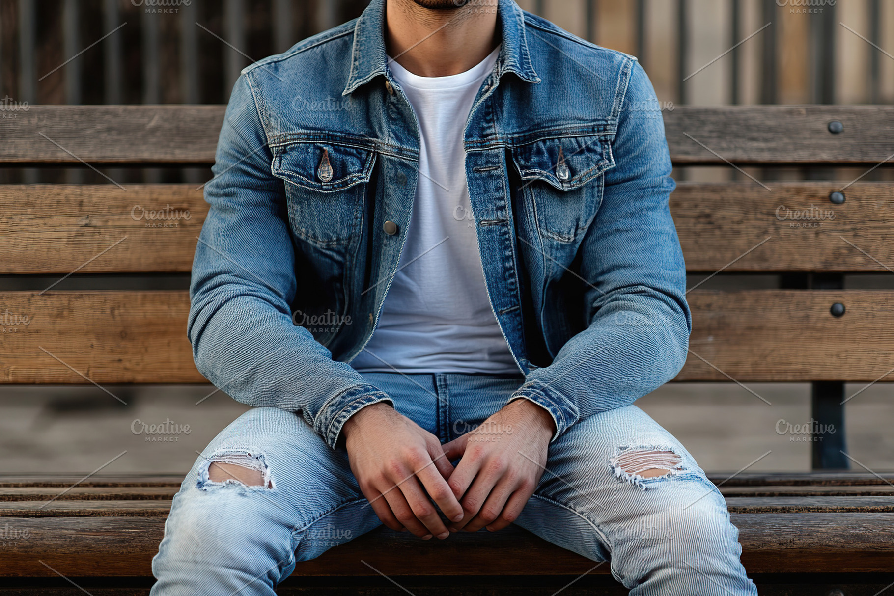 A young man in jeans clothing while sitting on a park bench, a Person Photo by AlyaAnd