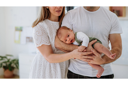 Happy parents cuddling with their, a Person Photo by HalfPoint