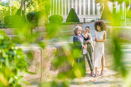 boss and two female employees chatting happily after work, a Business Photo by Iván Moreno STOCK PHOTO