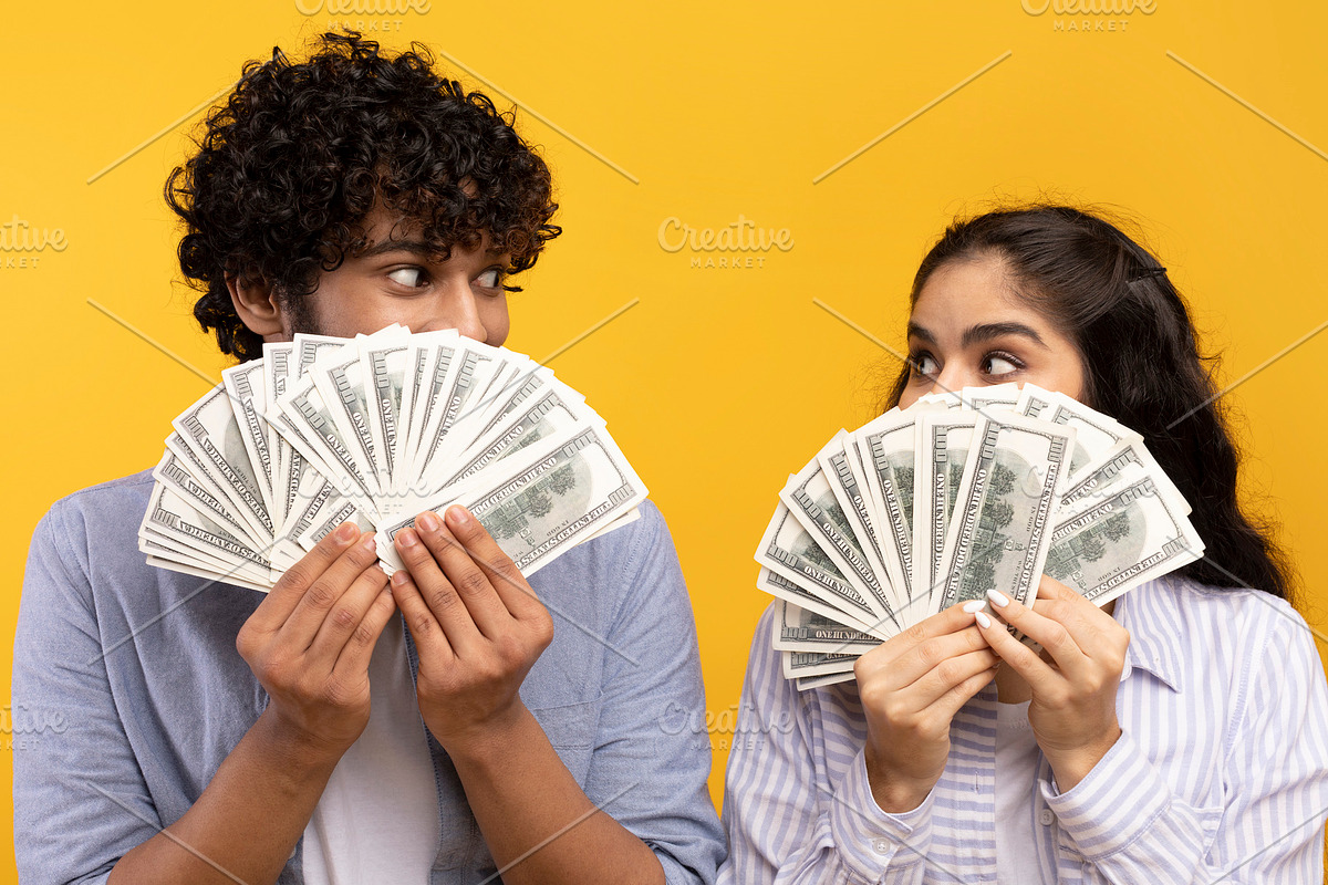 Big win concept. Young indian couple holding and covering faces with a lot of d, a Photo by Prostock-Studio (Photo 4 of 4)