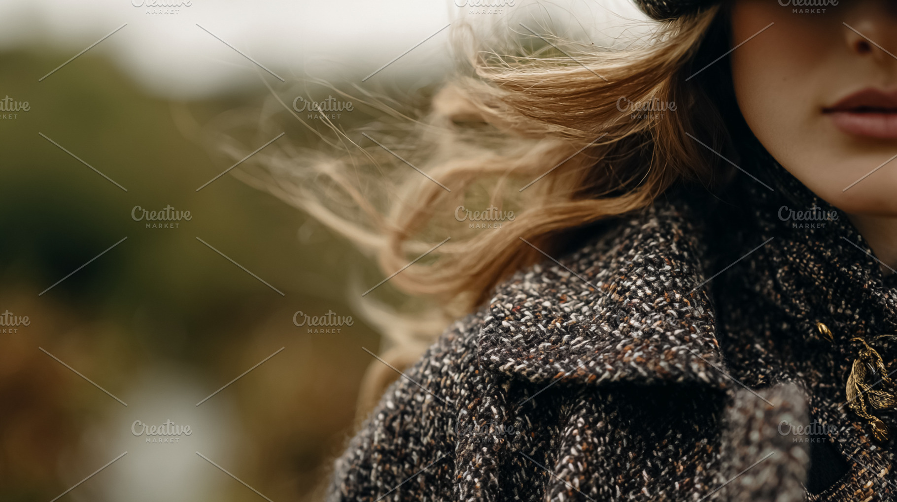 Woman's blonde hair blowing in the wind, wearing a tweed jacket, a Photo by Studio ANNA