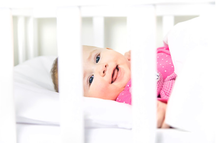 Baby toddler plays in the crib, a Person Photo by yanadjana