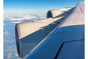 Wing with engines of airbus a380 flying over clouds featuring wing, travel, a Transportation Photo by Leonid Andronov