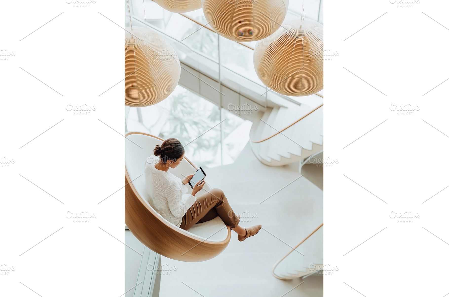 A woman sits in a modern lounge, an Architecture Photo by Sergey Kotenev