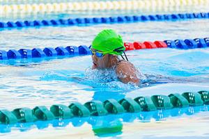 Swimmer child swims breaststroke swimming style in a race swimmi