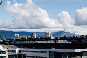 Scenic view of Reykjavik, Iceland architecture with mountains and clouds in bac, a Photo by AS photostudio