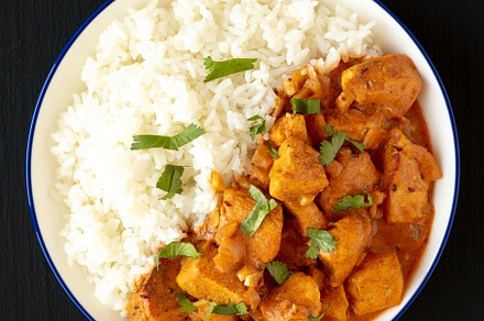 Homemade Easy Indian Butter Chicken with Rice on a Plate on a bl, a Food & Drink Photo by LiudmylaChuhunova
