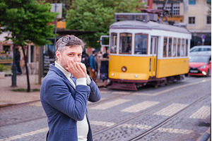 Man plays harmonica outdoors in city