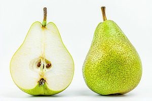 Green pear and pear half isolated on white background, a Food & Drink Photo by AlyaAnd