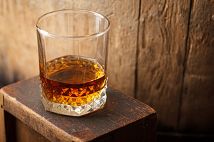 Glass of whiskey near a barrel featuring alcohol, barrel, and cask