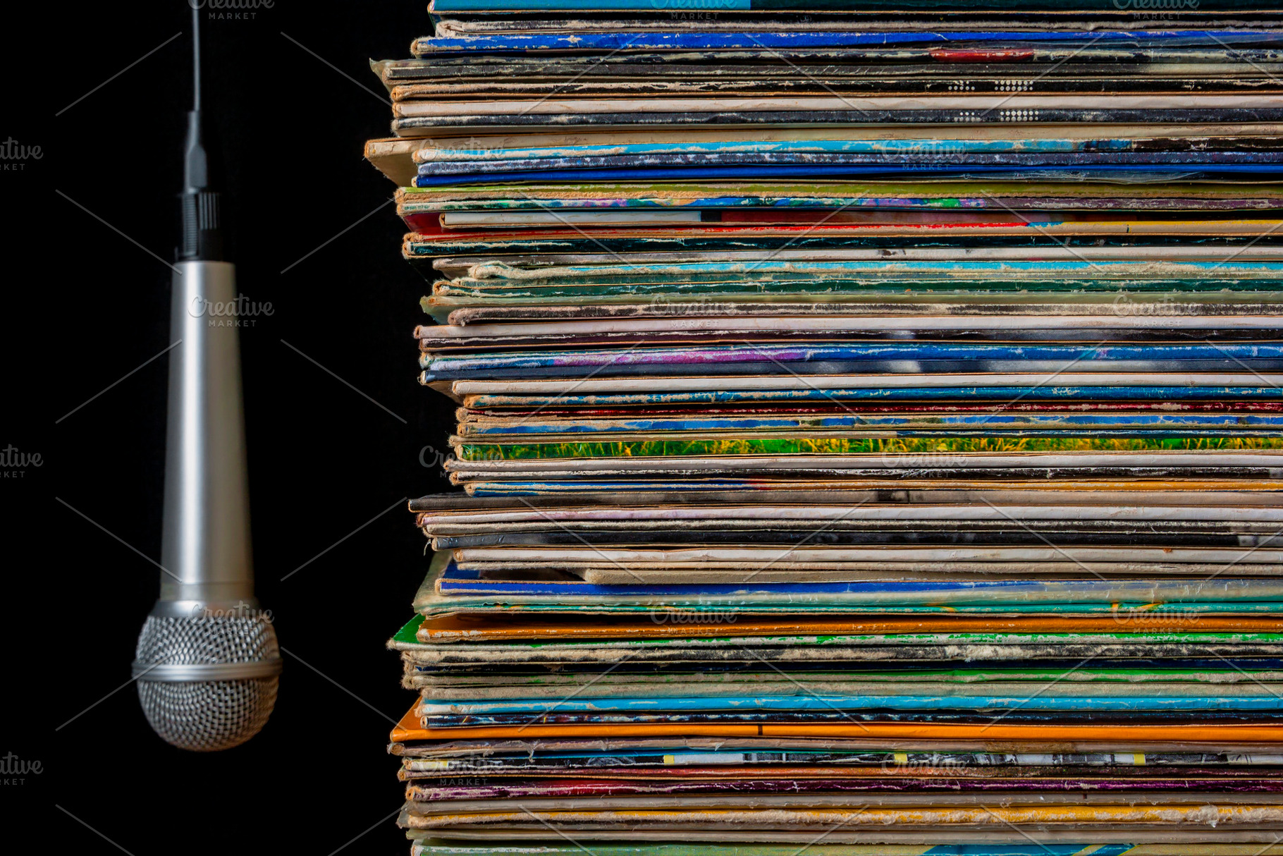 A stack of old records and hanging m containing microphone, records, and discs, an Arts & Entertainment Photo by SergeKa