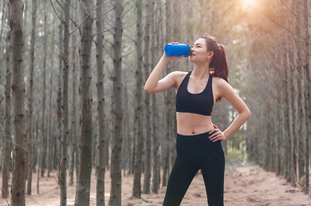 Beauty Asian sport woman resting and holding drinking water bott, a Sports & Recreation Photo by Ministocker