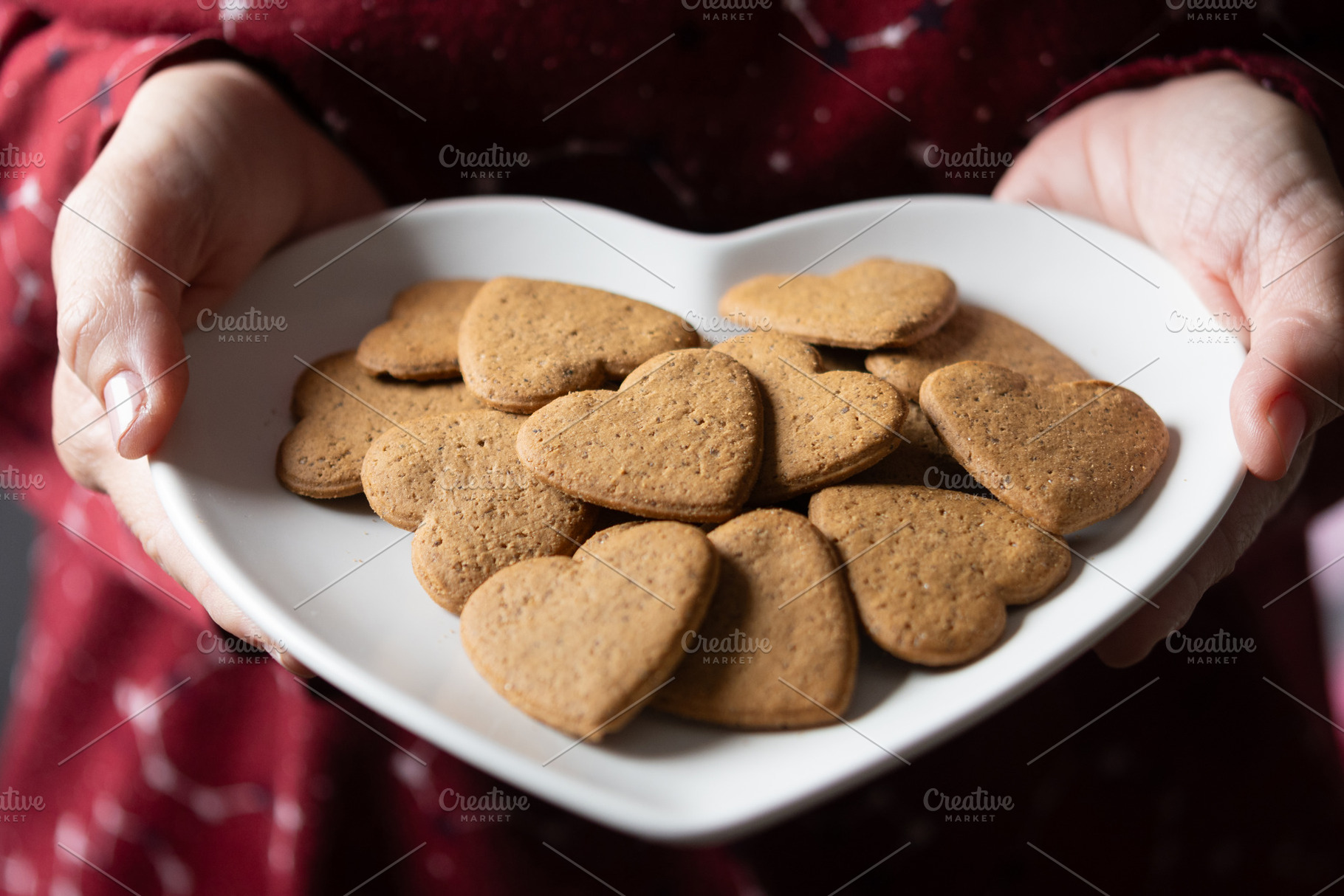 Hands holding a heart-shaped gingerbread cookies, a Food & Drink Photo by etorres69