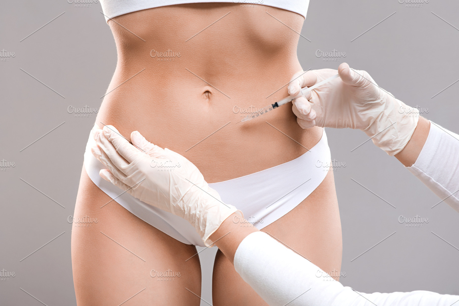 Slim lady having lipolysis treatment, a Photo by Prostock-Studio