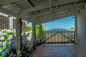 Garden gate with flowers under a bright summer sky, an Architecture Photo by DanFLCreativo