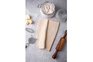 Raw puff pastry dough with baking, a Food & Drink Photo by Yulia Furman