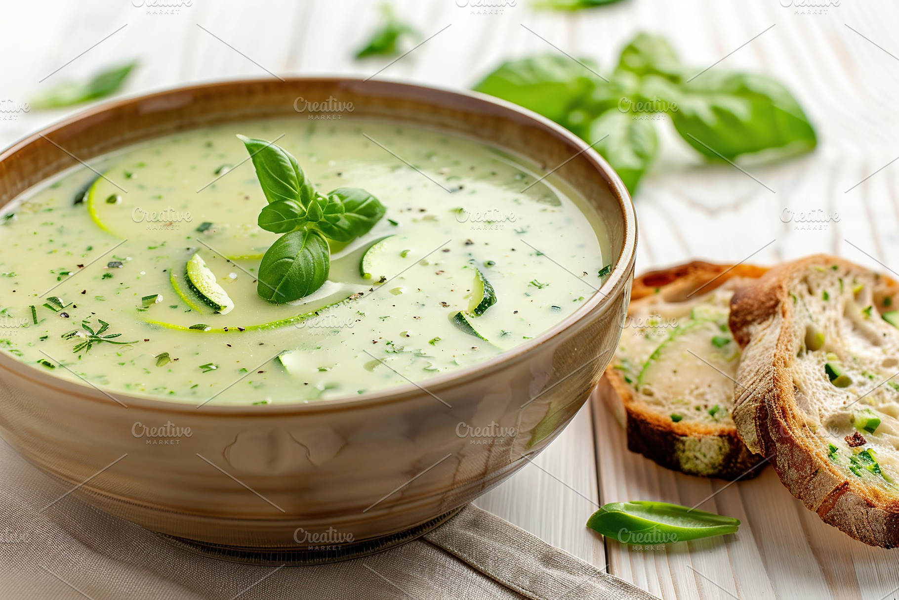 Zucchini cream soup puree in bowl and bread on wooden background, a Food & Drink Photo by AlyaAnd