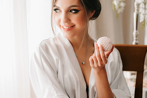 A young bride sits at a slot machine in the morning and drinks c