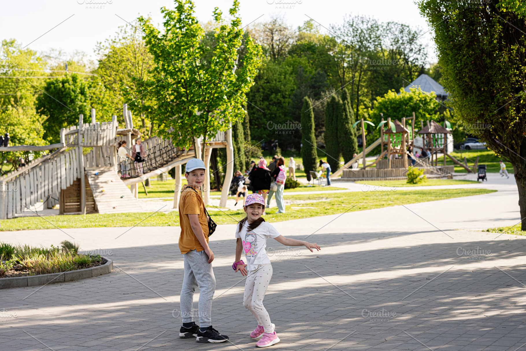 Children enjoying recreation at a park with lush green surroundings, a Person Photo by AS photostudio