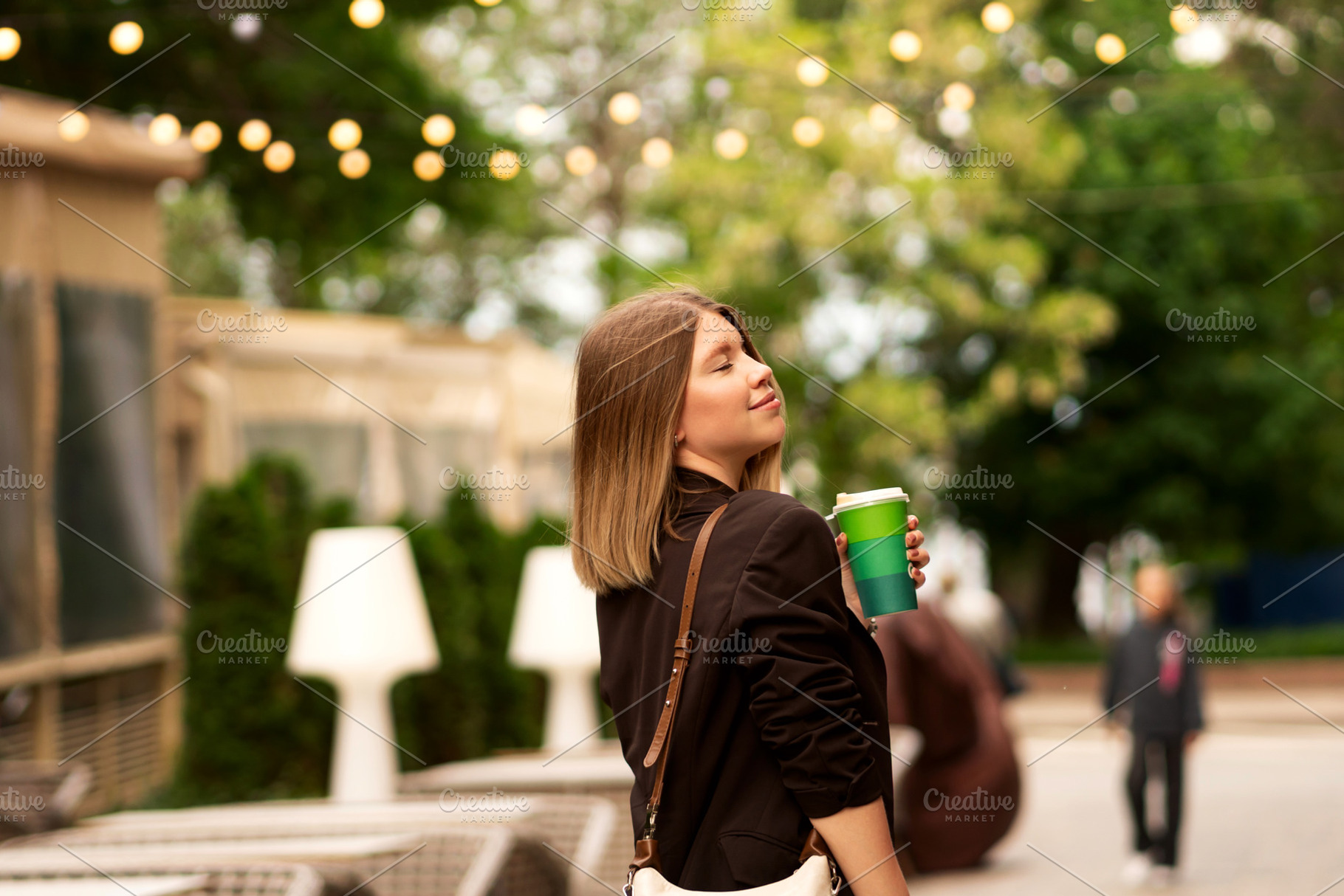 Young woman enjoying coffee outdoors, a Person Photo by Elena Vagengeim
