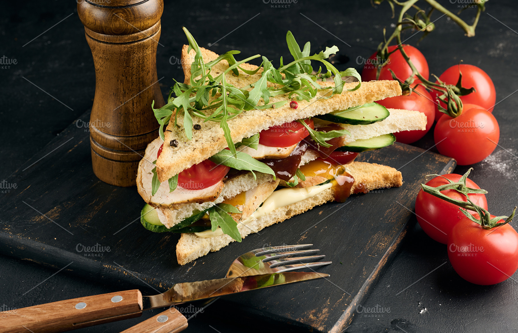 Grilled chicken sandwich with fresh tomatoes, cucumbers, arugula, a Food & Drink Photo by ndanko