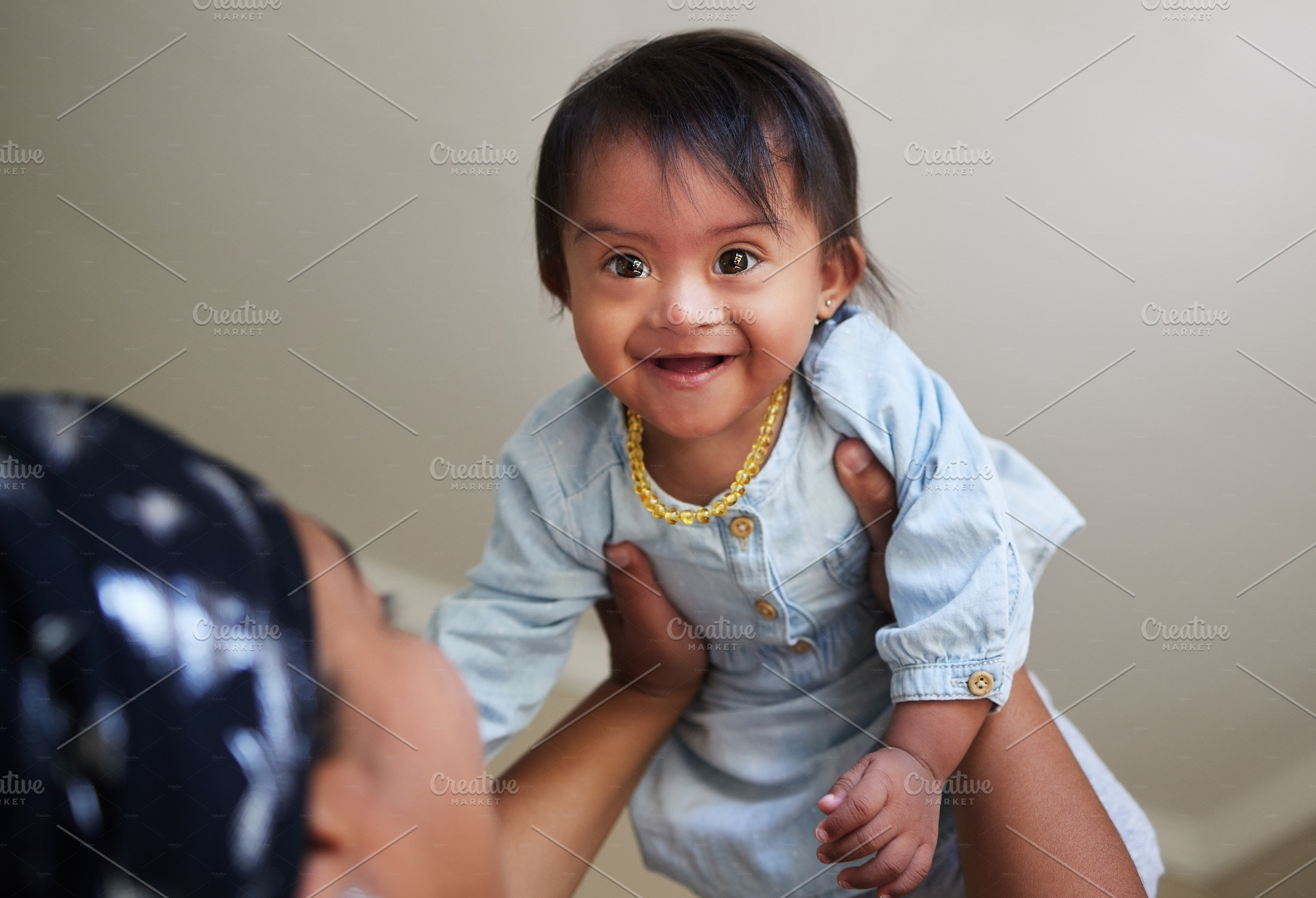 Happy, baby and child mom care of a woman holding a kid in the air feeling happiness at a house. Happiness and smile of a young toddler face from India in a home spending quality time with a mother, a Photo by Peopleimages.com