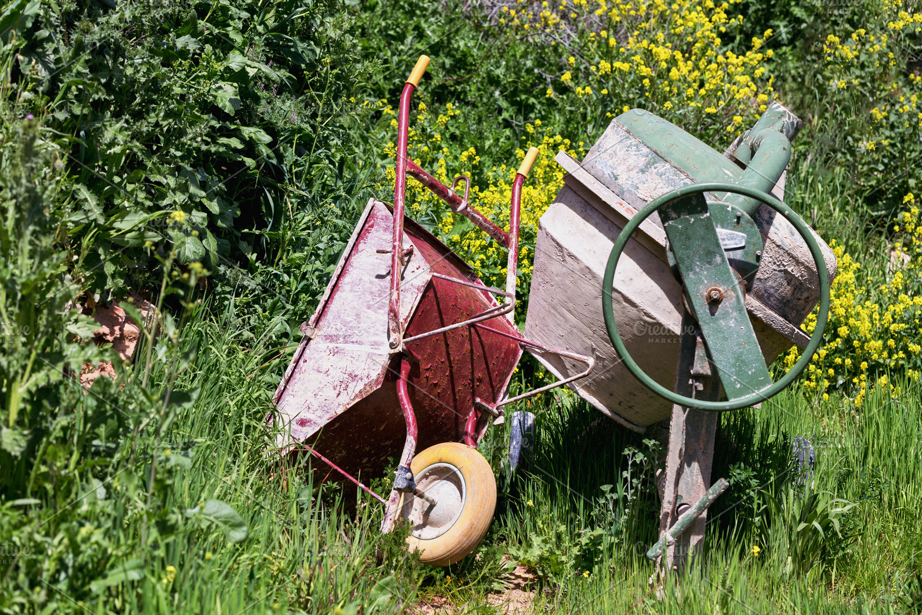 Red Wheelbarrow and Cement Mixer in, an Industrial Photo by Perpis