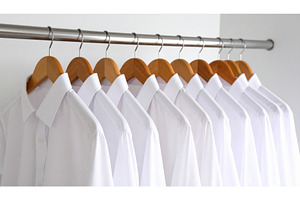 Row of neatly arranged white shirts, a Beauty & Fashion Photo by Igor Tichonow