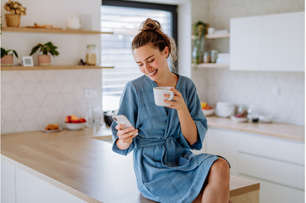 Young woman with smartphone enjoying, a Person Photo by HalfPoint
