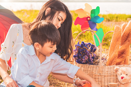 Beautiful Asian mother and son doing picnic and in Easter summer, a Person Photo by Ministocker