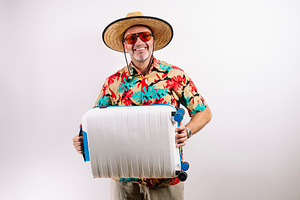 Traveler ready for adventure with suitcase, a Holiday Photo by karrastock