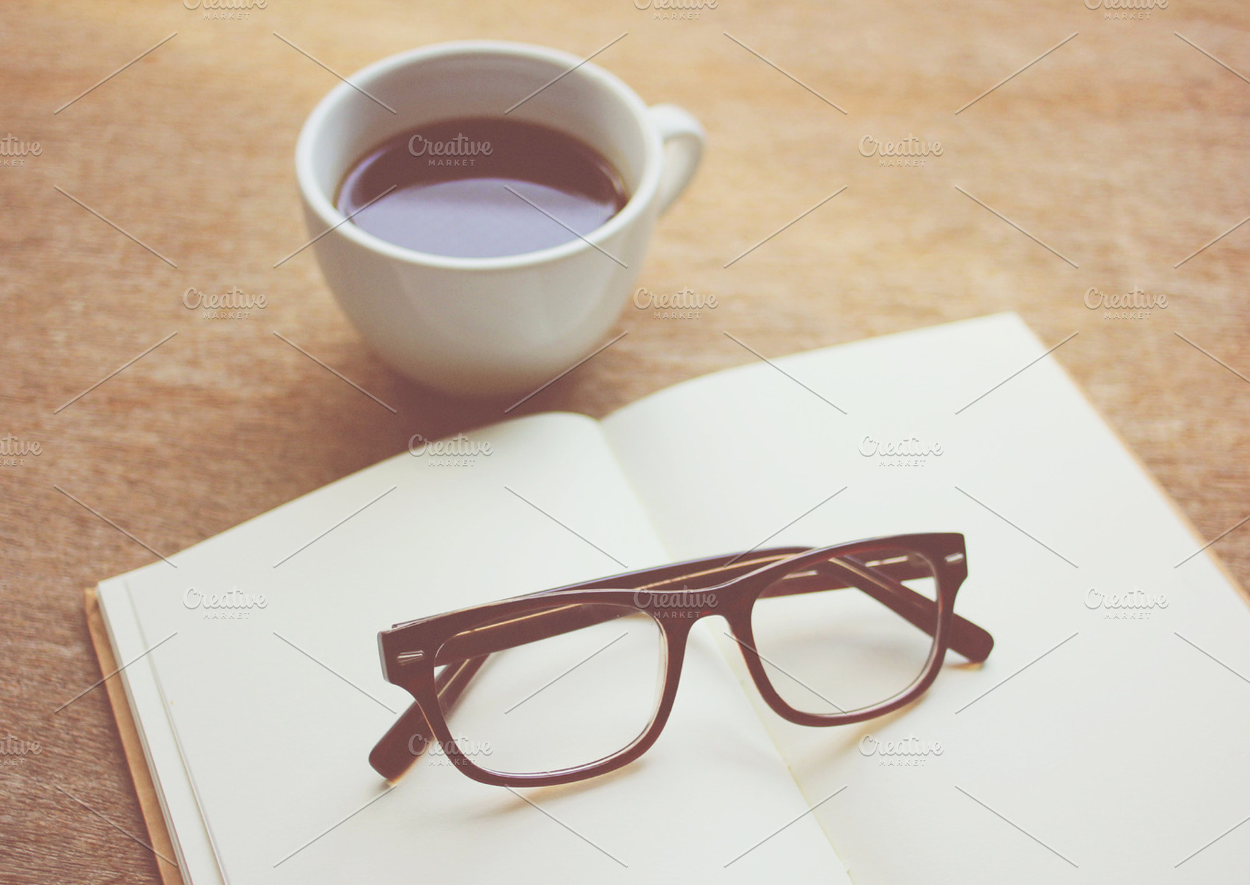 Eyeglasses On Notebook And Coffee