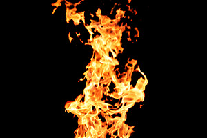 Intense tongues of orange and yellow flame, small glowing sparks, a Background Photo by ndanko