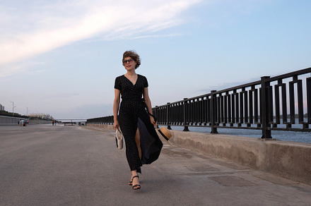Woman in wrap dress walks